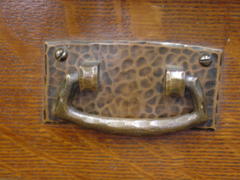 Close-up hand-hammered copper drawer pull.